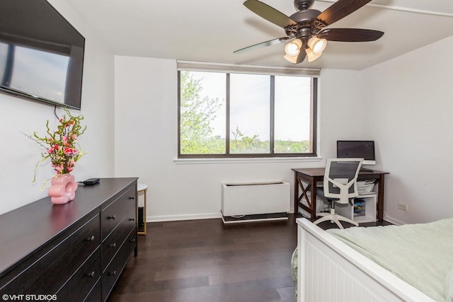 bedroom featuring dark wood finished floors, baseboards, ceiling fan, and a desk