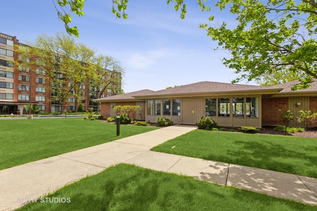 2000 Saint Regis Dr Unit 6F, Lombard, IL 60148 - view of front of house featuring a front lawn and a shingled roof
