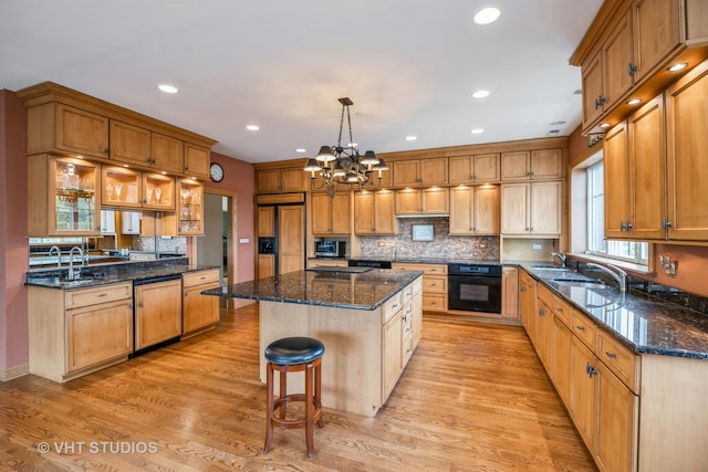 444 Ashland Ave Unit 5, River Forest, IL 60305 - kitchen with paneled appliances, a center island, a breakfast bar area, backsplash, and light wood finished floors