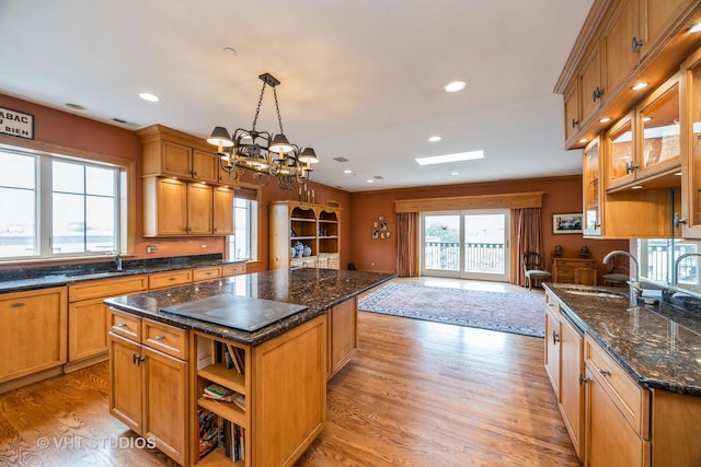 444 Ashland Ave Unit 5, River Forest, IL 60305 - kitchen featuring a sink, stovetop, a kitchen island, light wood-style floors, and a chandelier
