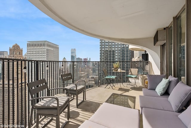 balcony with a skyline view and an outdoor living space