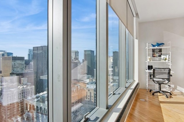 interior space with a city view and baseboard heating