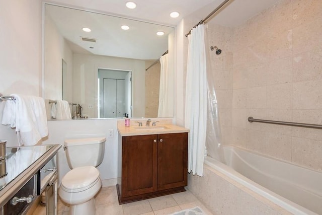 bathroom with toilet, tiled shower / bath, visible vents, tile patterned floors, and vanity