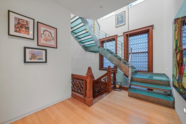 staircase with wood finished floors and baseboards