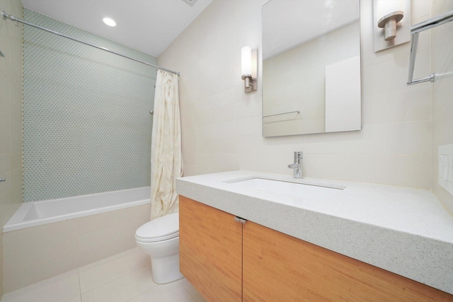 bathroom with tiled shower / bath combo, recessed lighting, toilet, tile patterned flooring, and vanity