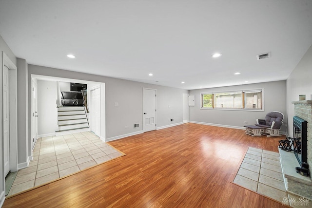 8S100 Washington St, Darien, IL 60561 - unfurnished living room featuring a fireplace, light wood-style floors, stairs, recessed lighting, and baseboards