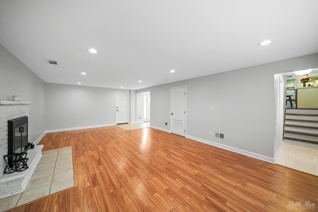 8S100 Washington St, Darien, IL 60561 - unfurnished living room with stairway, light wood-type flooring, a fireplace, recessed lighting, and baseboards