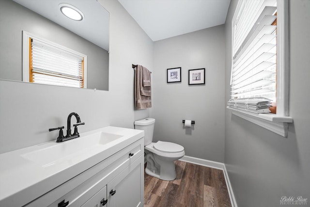8S100 Washington St, Darien, IL 60561 - bathroom featuring wood finished floors, toilet, vanity, and baseboards