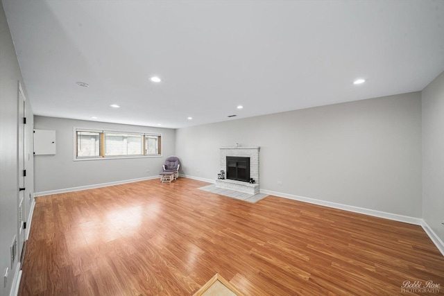 8S100 Washington St, Darien, IL 60561 - unfurnished living room with light wood-type flooring, a fireplace, baseboards, and recessed lighting