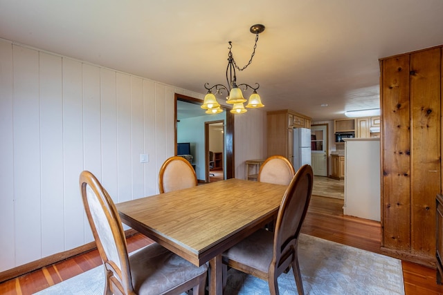 dining area featuring an inviting chandelier and wood finished floors