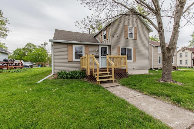 traditional home with a deck, roof with shingles, and a front yard