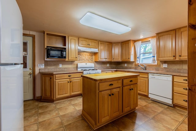 kitchen featuring a sink, white appliances, tasteful backsplash, butcher block counters, and under cabinet range hood