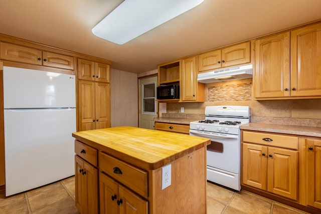 kitchen featuring under cabinet range hood, light tile patterned flooring, white appliances, and wood counters