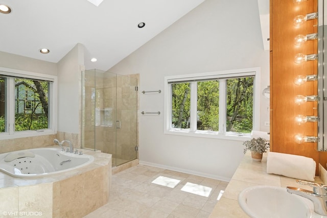 bathroom featuring a sink, healthy amount of natural light, tile patterned flooring, a stall shower, and high vaulted ceiling