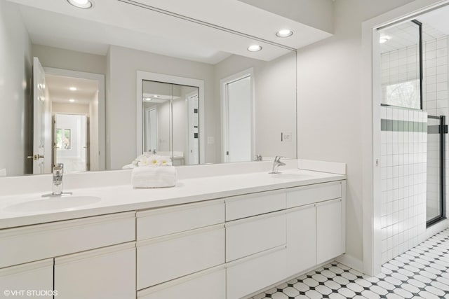 full bath featuring recessed lighting, double vanity, and a tile shower