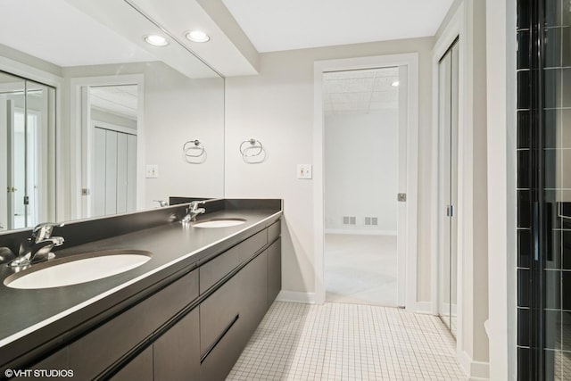 bathroom featuring recessed lighting, baseboards, double vanity, and tile patterned floors