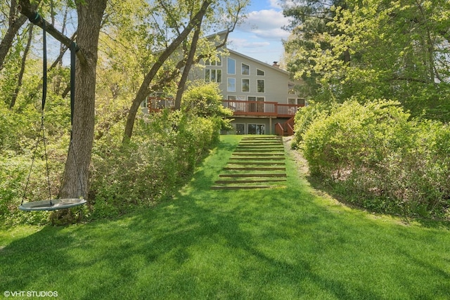 view of green lawn featuring a deck