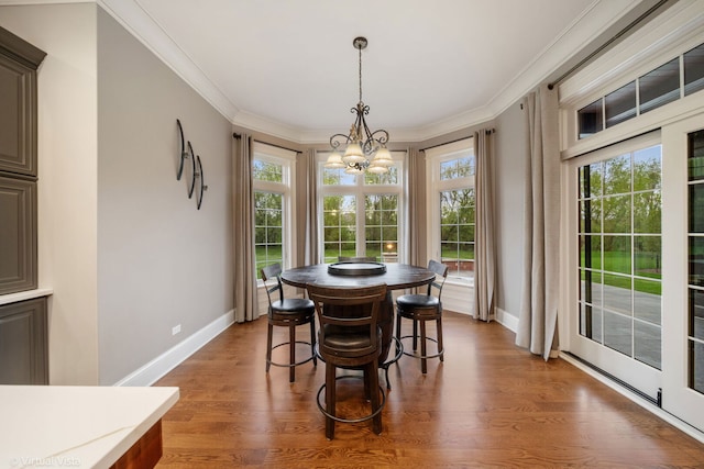 dining space with an inviting chandelier, baseboards, and a healthy amount of sunlight