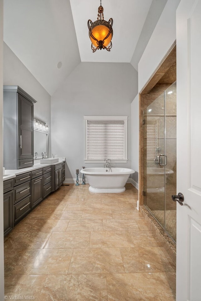 full bathroom featuring high vaulted ceiling, baseboards, a shower stall, a freestanding tub, and vanity