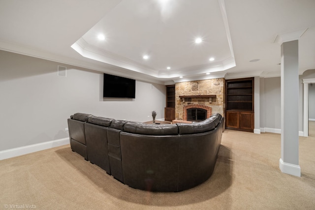 living area featuring light carpet, crown molding, a raised ceiling, and a large fireplace