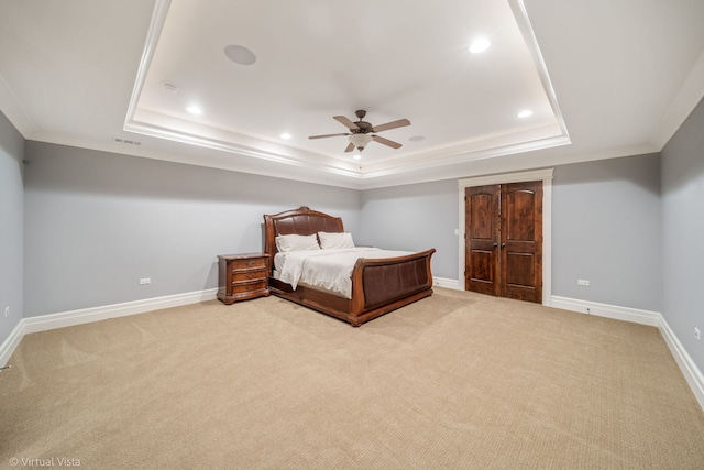 bedroom with a tray ceiling, recessed lighting, baseboards, carpet flooring, and visible vents