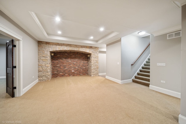 finished basement with crown molding, stairs, visible vents, and carpet floors