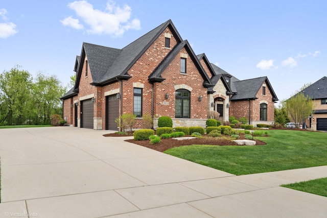 view of front of house with roof with shingles, stone siding, brick siding, concrete driveway, and a front lawn