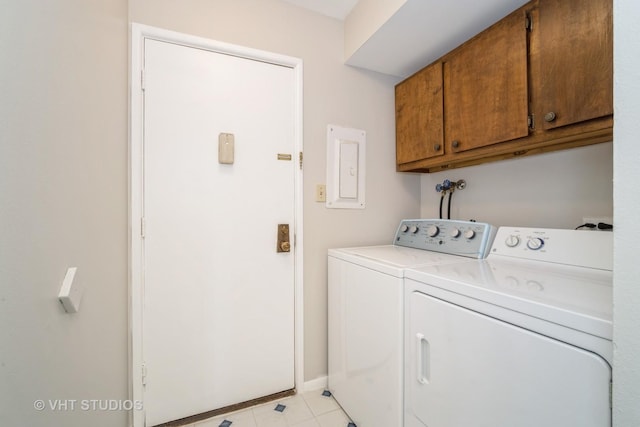laundry room with cabinet space, separate washer and dryer, light tile patterned flooring, and baseboards