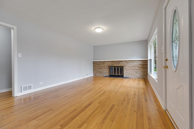 205 S 10th Ave, Saint Charles, IL 60174 - unfurnished living room featuring light wood-type flooring, baseboards, and a brick fireplace