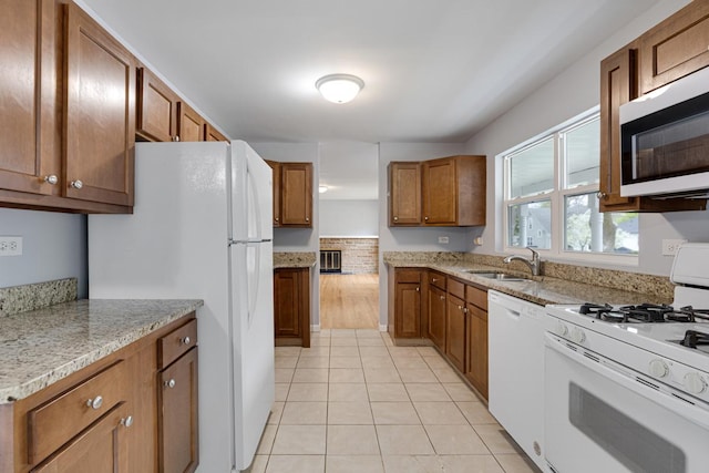 205 S 10th Ave, Saint Charles, IL 60174 - kitchen featuring white appliances, a sink, brown cabinets, light tile patterned floors, and light stone counters