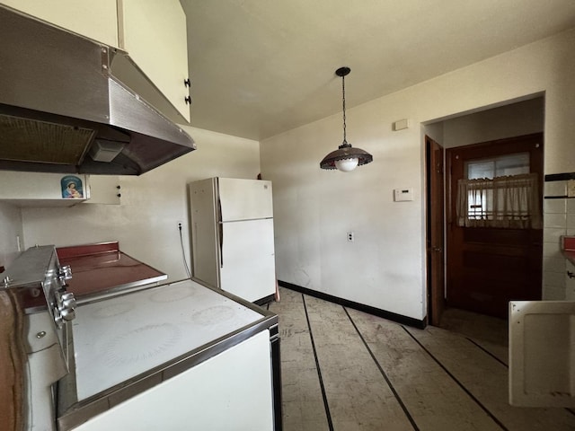 kitchen featuring freestanding refrigerator, light wood-type flooring, under cabinet range hood, hanging light fixtures, and baseboards