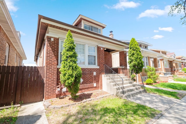 bungalow-style home featuring brick siding