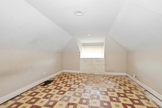 bonus room featuring vaulted ceiling, baseboards, and light flooring