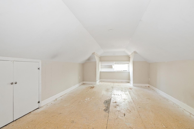 additional living space featuring vaulted ceiling