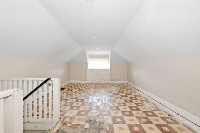bonus room featuring tile patterned floors, lofted ceiling, and baseboards