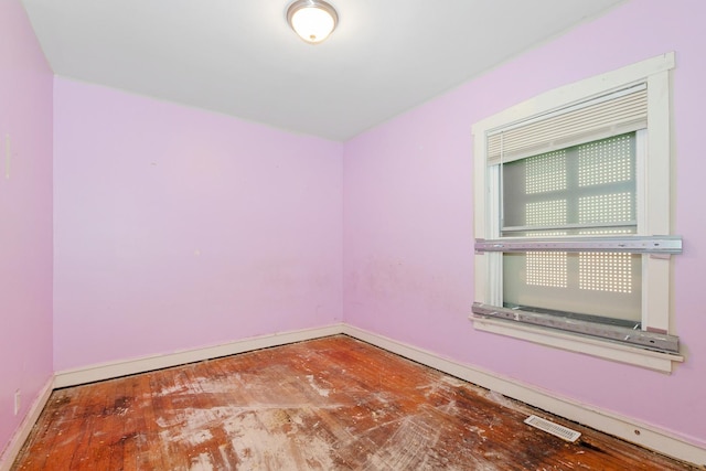 empty room featuring baseboards and wood finished floors