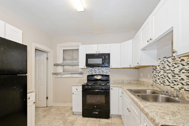 kitchen with black appliances, a sink, white cabinets, and light countertops