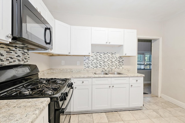 kitchen featuring black appliances, tasteful backsplash, white cabinets, and a sink
