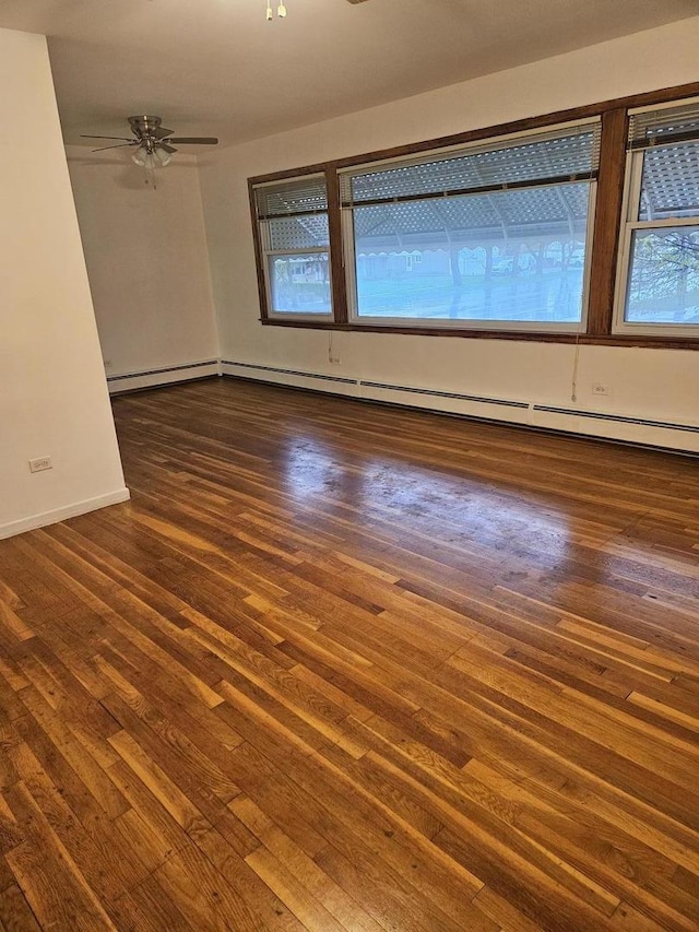 7202 W Crain St, Niles, IL 60714 - empty room featuring a baseboard heating unit, baseboards, and hardwood / wood-style flooring