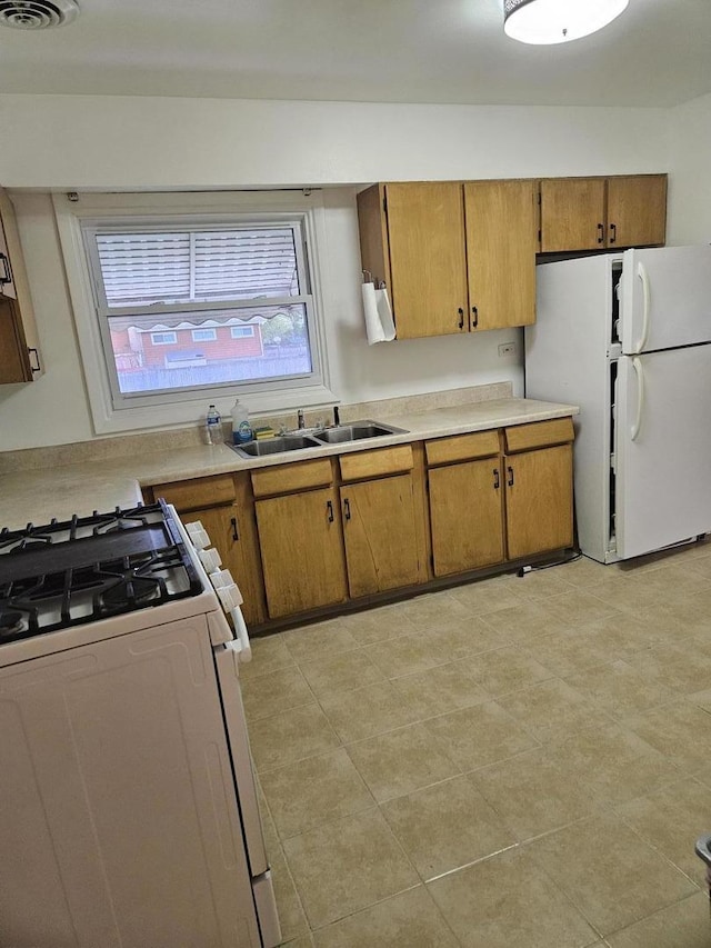 7202 W Crain St, Niles, IL 60714 - kitchen featuring brown cabinetry, white appliances, light countertops, and a sink