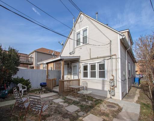 back of property featuring a patio and fence