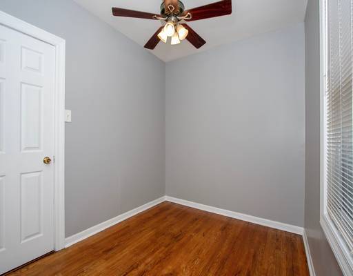 spare room featuring baseboards, a ceiling fan, and wood finished floors