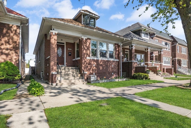 view of front of home with brick siding and a front yard