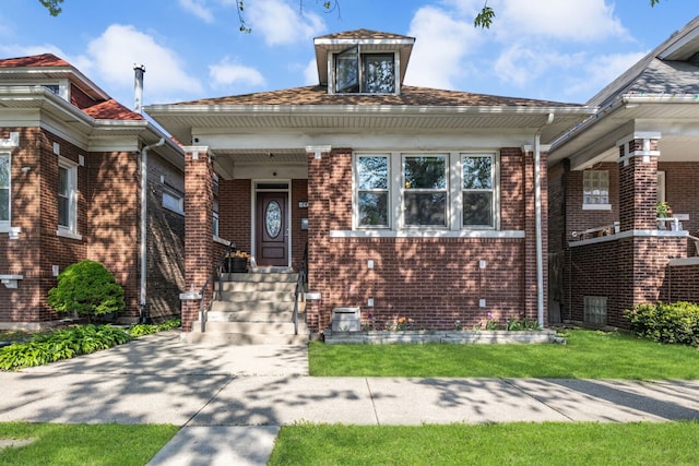 bungalow-style house featuring brick siding