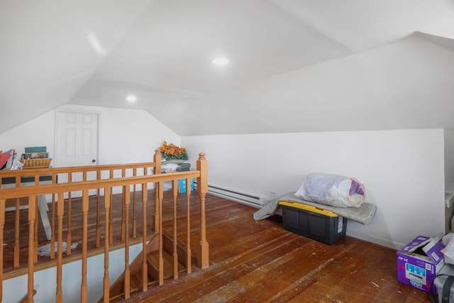 additional living space featuring vaulted ceiling, baseboard heating, wood-type flooring, and recessed lighting