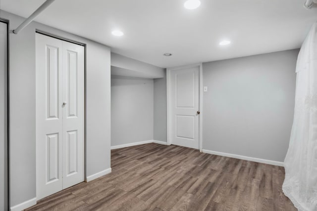 finished basement with recessed lighting, baseboards, and wood finished floors