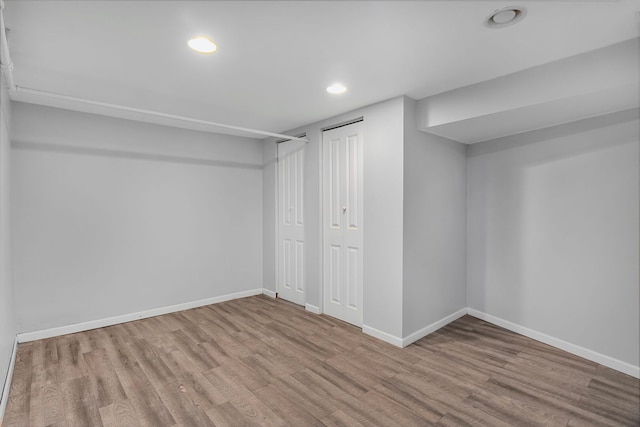 finished basement featuring recessed lighting, baseboards, and wood finished floors