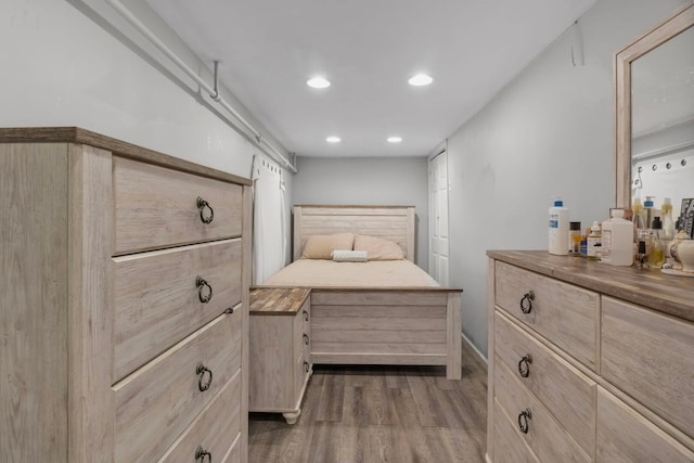 bedroom with dark wood-style floors and recessed lighting