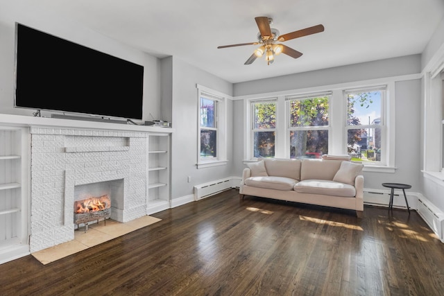 living room with a baseboard heating unit, a wealth of natural light, ceiling fan, and wood finished floors