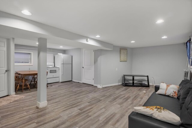 living area with light wood finished floors, baseboards, and recessed lighting